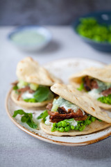 Mini flat breads with crispy lamb, mashed peas, cucumber, mint and yogurt sauce
