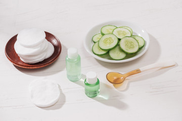 Cosmetic bottle and fresh organic cucumber for skincare. Home spa concept.