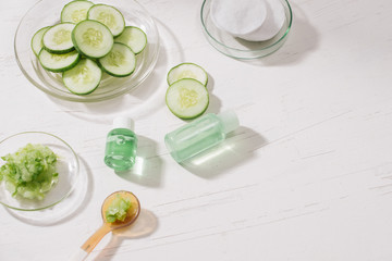 Cosmetic bottle and fresh organic cucumber for skincare. Home spa concept.