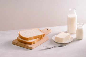 Sliced bread bake and butter on wooden cutting board. Simple breakfast