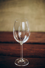 cropped glass of white wine on a rustic wooden brown background. rest, holiday, party. alcoholic drink closeup. copy space