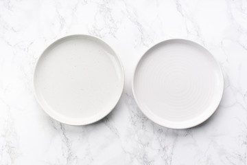Porcelain plates of various forms on marble surface