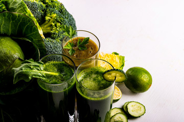 Vegan food and drinks with spinach, kiwi and cucumber on the white wooden background. Raw drinks and foods. Macro