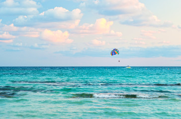 Vibrant image of people parasailing on a colorful parachute