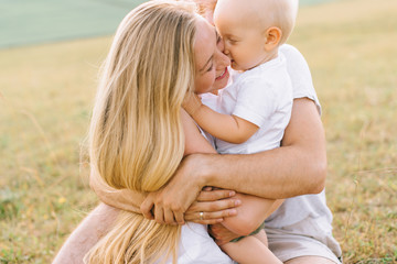 a young happy family in the field have a fun