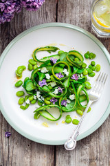 Salad with asparagus ribbons, broad beans and lilac