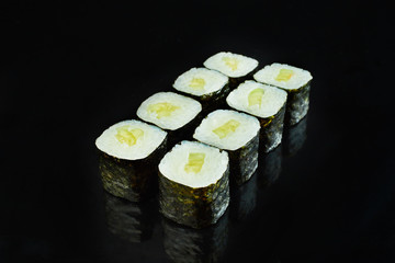 Classical vegan roll sushi maki  with cucumber isolated on black background for menu. Japanese food