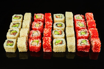 Various kinds of tasty sushi roll  isolated on black background for menu. Japanese food