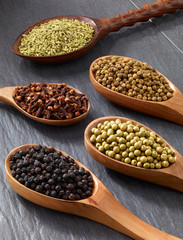 Indian pepper, clove and cumin arranged in spoon