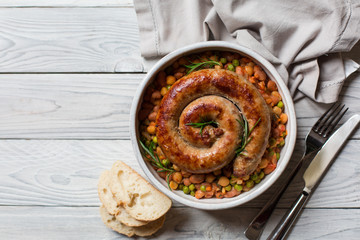 Italian sausage - salsiccia fresca, with bean stew and rosemary on a white background