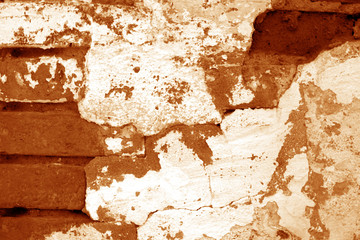 Old grungy brick wall texture in orange tone.