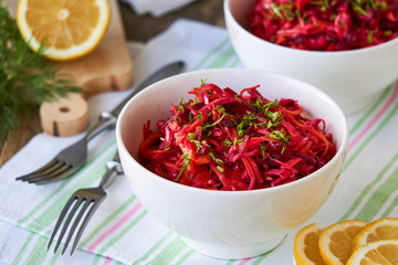 Vegetable salad with beets, cabbage and carrots in a white bowl    