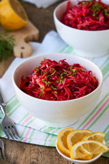 Vegetable salad with beets, cabbage and carrots in a white bowl    