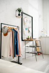 Modern light teenage bedroom with straight rack and pinboards