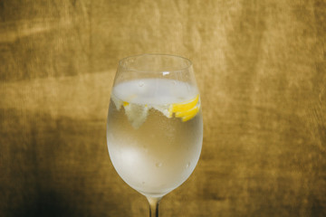 A glass of white wine on a rustic wooden red background. rest, holiday, party. crystal glass closeup. copy space. top view