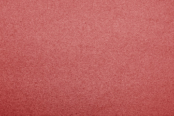 Plastic glittering texture in red color.