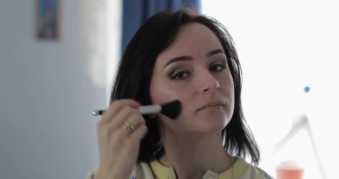 Young, pretty woman in pajamas near mirror. Beauty and makeup concept