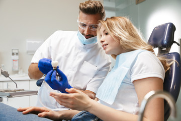 Happy young woman sitting in medical dentist center.