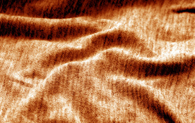 Fototapeta na wymiar Textile texture with blur effect in orange color.