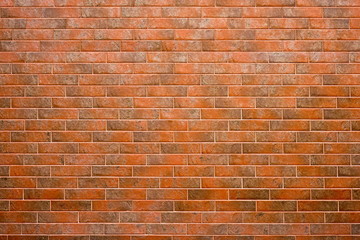 Obraz premium The wall is lined with red brick tiles.