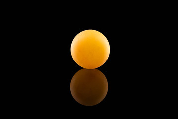 Yellow ping pong ball with reflection