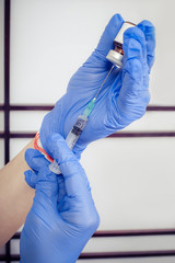 Woman hand with syringe, hypodermic needles and dermal liquid lift