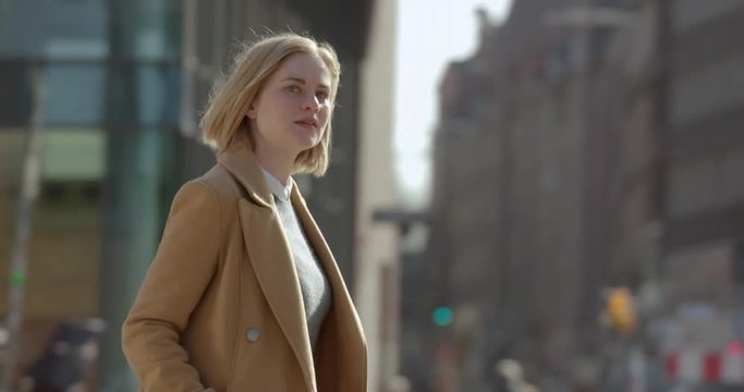 Attractive female crossing the street on a sunny day in the city