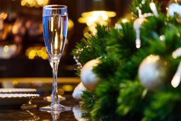 Glasses with a drink standing on the table. Festive table setting with a beautiful reflection.