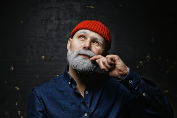 brutal man with a beard in winter clothes / portrait person with a gray beard, hipster warm clothes winter