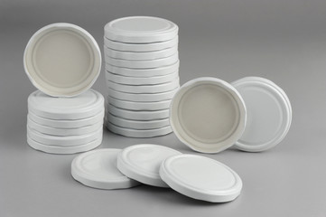 Screw caps for glass jars. For canning, canned food. White caps on gray background