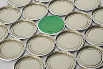 Screw caps for glass jars. For canning, canned food. White caps and one green on gray background