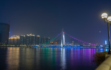 the Pearl River with Liede Bridge illuminated at night in Guangzhou, China