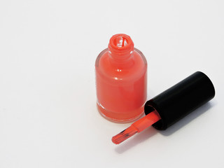 Orange nail polish bottle on white background.Cosmetics and beauty concept. Top view, flat lay. Free Copy space. Beauty blogger concept. Nail polish.