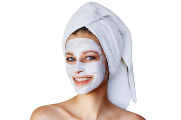 Beautiful young woman with facial mask on her face. Skin care and treatment, spa, natural beauty...