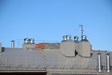 shiny metal air ventilation on roof rotates to clean  air in  building and regulate  temperature.