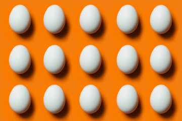 Eggs on an orange background, making a pattern.