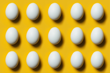 Eggs on a yellow background, making a pattern.