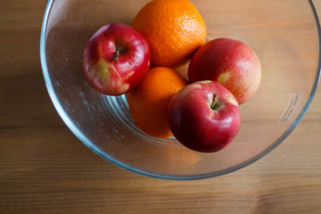 oranges and apples on wooden background