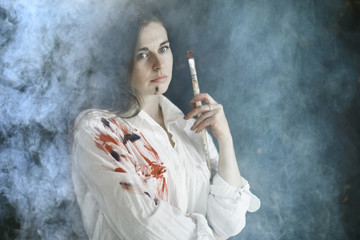 Obraz premium Young artist girl at work in the workshop brush paints canvas inspiration