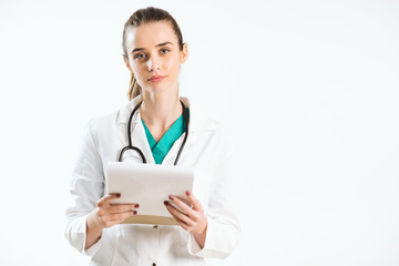 Young nurse with stethoscope and papers in her scrub uniform.