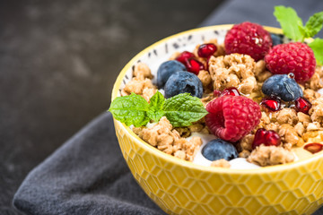 Breakfast or brunch, granola with milk and berry fruits