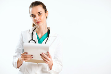 Young nurse with stethoscope and papers in her scrub uniform.