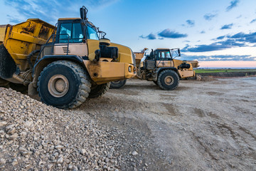 Large trucks in an open pit mine