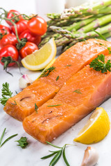 Cold smoked salmon fish fillets with lemon,spices and herbs