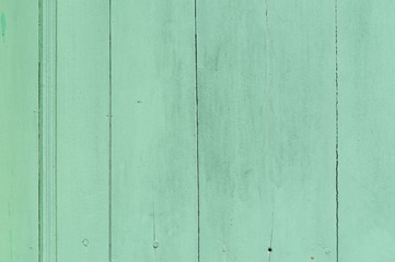 Obraz premium Faded green or blue wooden background with some cracked spots and vertical pattern on it