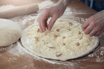 A man is cooking pizza. The cooking process.