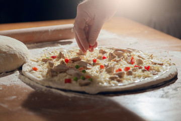 A man is cooking pizza. The cooking process.