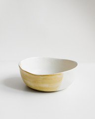 Elegant cutlery on a isolated background. Front view. Porcelain ivory yellow soup bowl. Ceramic plate. Flat lay view.