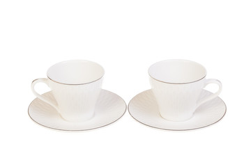 Two white porcelain tea, coffee cups with saucer. Isolated on white
