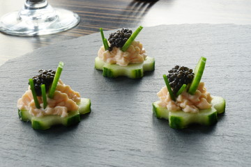 black caviar on canape with cucumber 